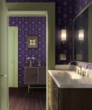 Art Deco bathroom with purple geometric wallpaper and golden accents