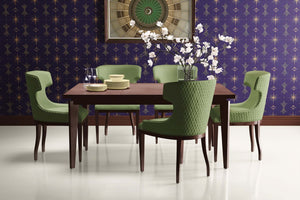 Dining room with Deco Twilight Art Deco wallpaper featuring geometric patterns, green chairs, and wooden table.