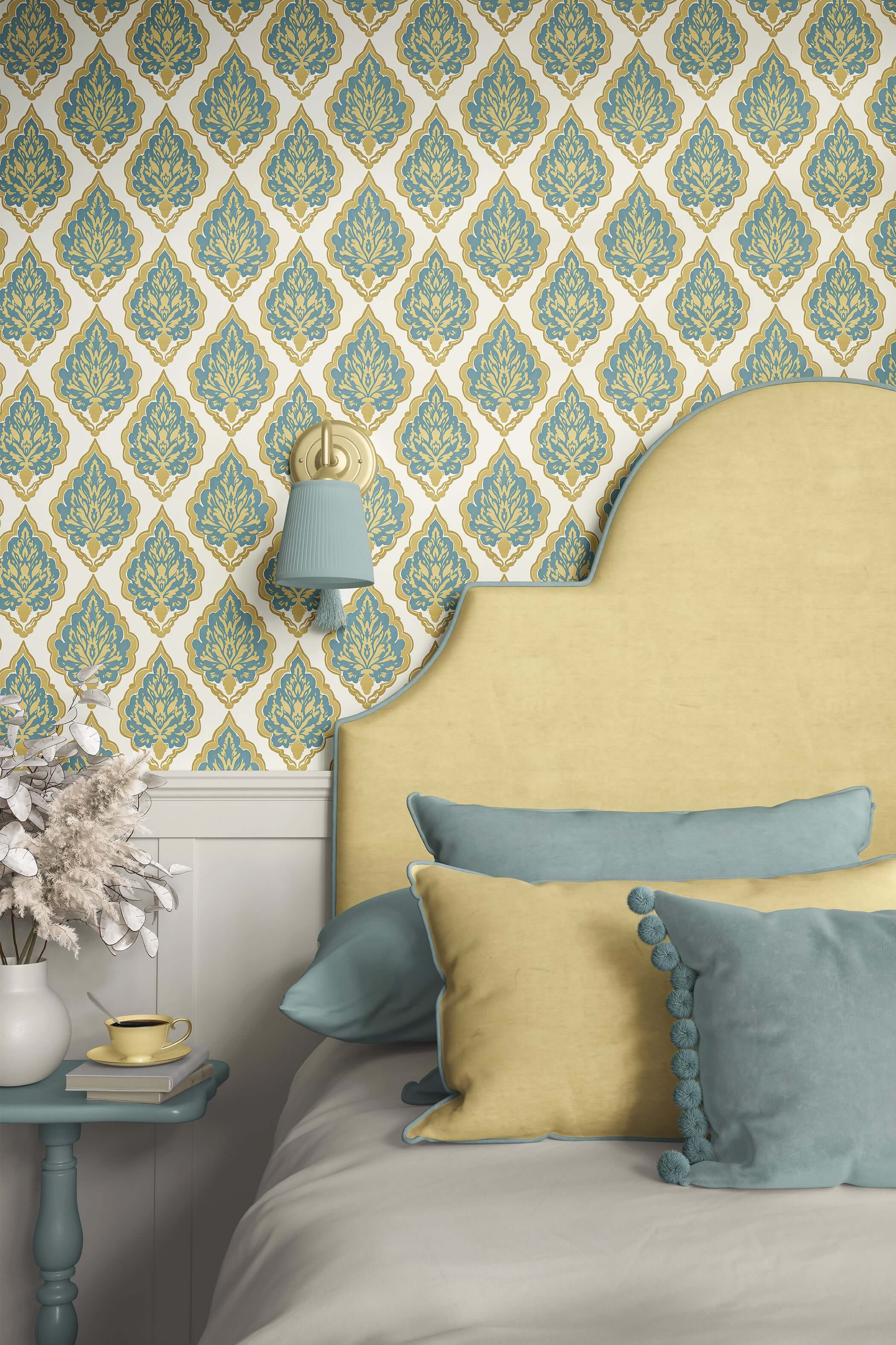 Elegant bedroom with teal and gold damask wallpaper, matching teal pillows, and a soft beige headboard for a vintage look.