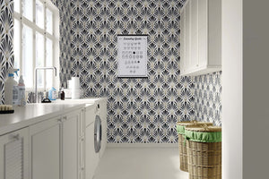 Black and white Art Deco wallpaper with geometric fan motifs in a chic laundry room, showcasing Deco Dynasty's sophisticated design.