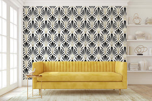 Art Deco geometric wallpaper with black and white fan motifs and gold lines in a luxurious living room with a yellow couch.