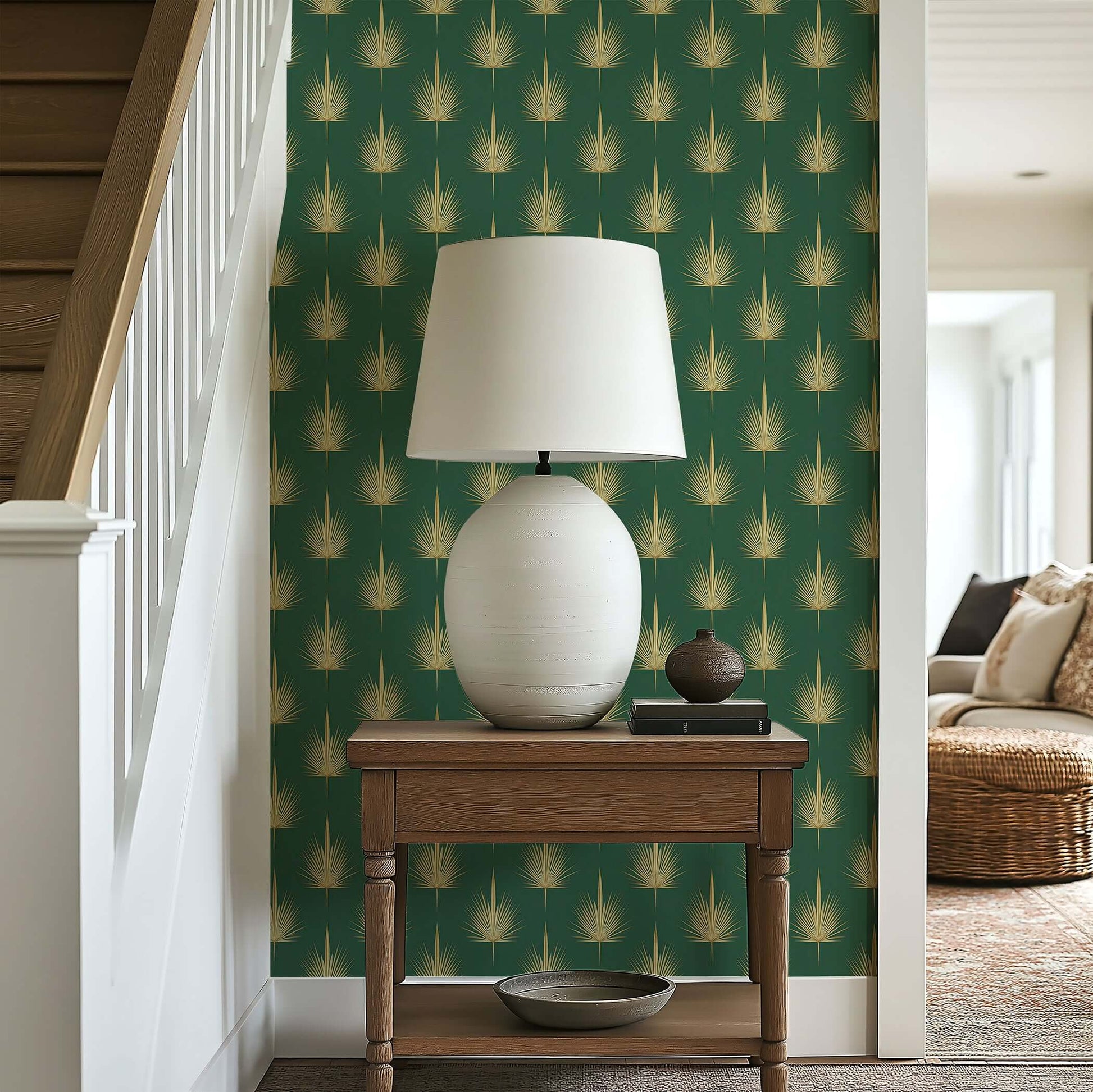 Living room with Gilded Palm Luxury Wallpaper featuring art deco palm leaves in gold on green, complemented by a table lamp.