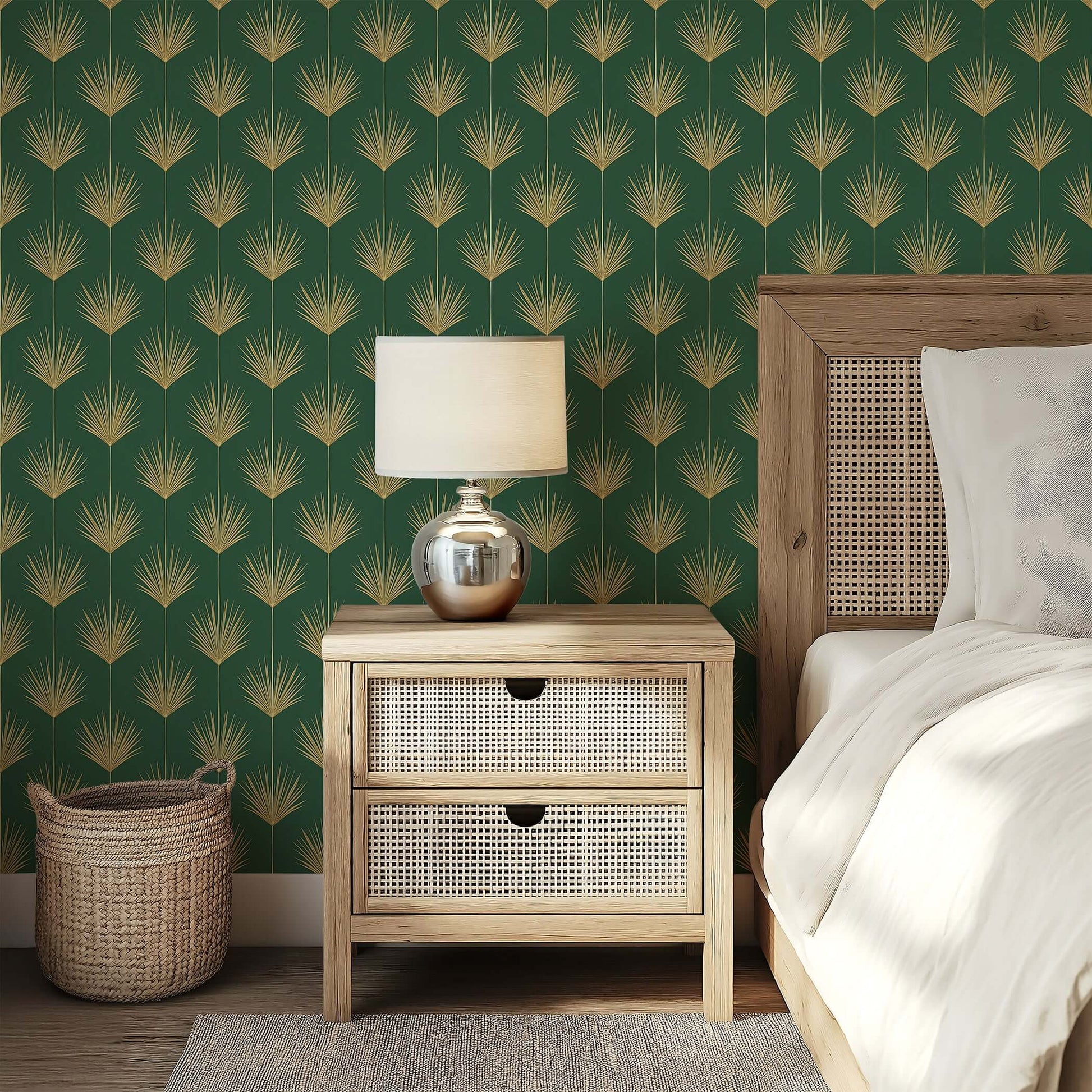 Bedroom with Gold Leaf Tropics art deco wallpaper featuring gold palm leaves on a green background next to a wooden nightstand.