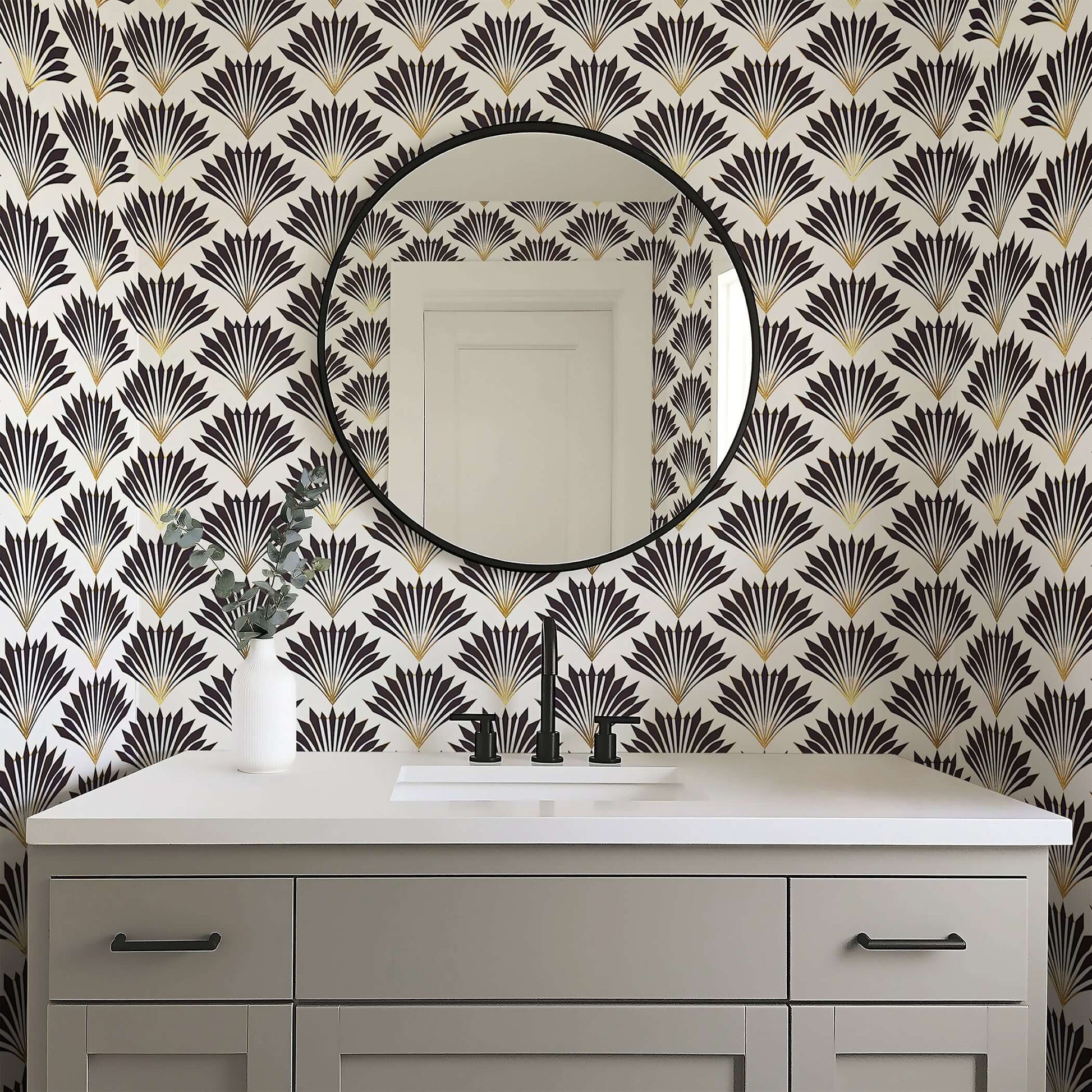 Art Deco wallpaper with black and gold geometric fan motifs creating vintage elegance in a modern bathroom space.