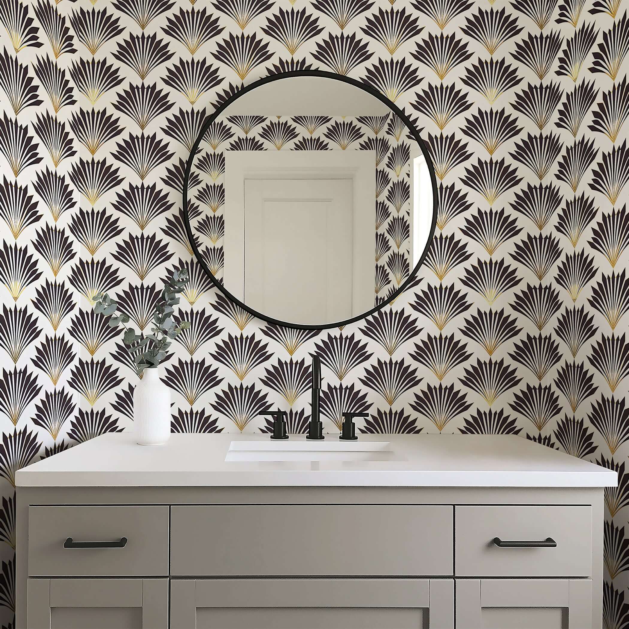 Art Deco wallpaper with black and gold geometric fan motifs creating vintage elegance in a modern bathroom space.