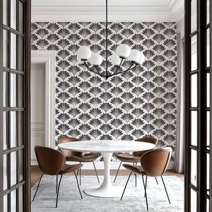 Dining room with Metropolitan Deco geometric wallpaper featuring black and gold Art Deco fan motifs, emphasizing vintage elegance.