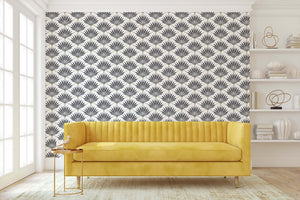 Art Deco wallpaper with black-and-white fan palm fronds, geometric design, in a room with a yellow sofa. Perfect for statement walls.