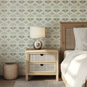 Bedroom with Ginkgo Harmony wallpaper featuring modern floral design in sage and gold, wooden furniture, and a soft lamp.
