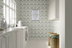 Ginkgo Harmony wallpaper in a modern laundry room, featuring coastal floral design with ginkgo flowers in sage and gold tones.