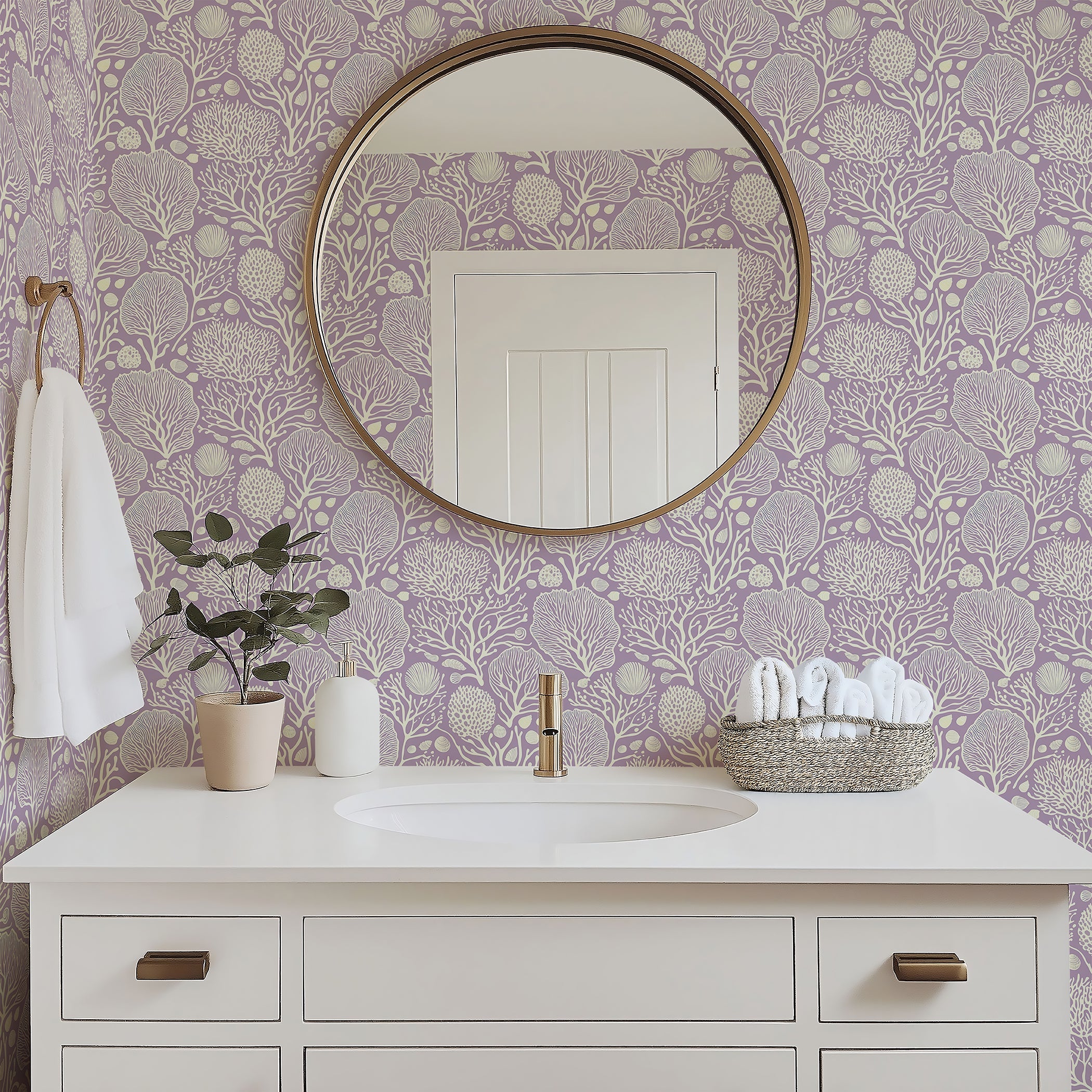 Lavender Coral Oasis wallpaper in a bathroom with white vanity and round mirror, showcasing marine-inspired design and tranquil coastal ambiance.