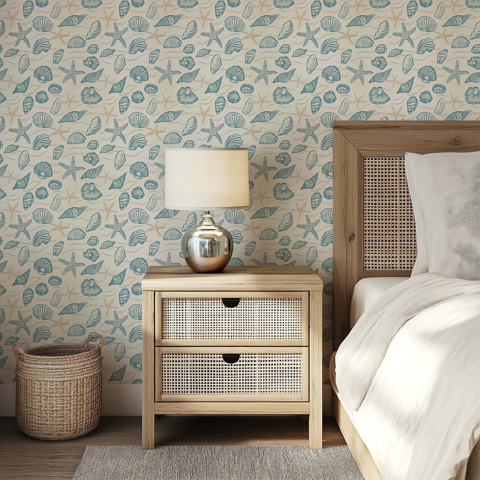 Coastal wallpaper featuring hand-drawn seashells and starfish in ocean blues, enhancing a serene bedroom setting with marine charm.