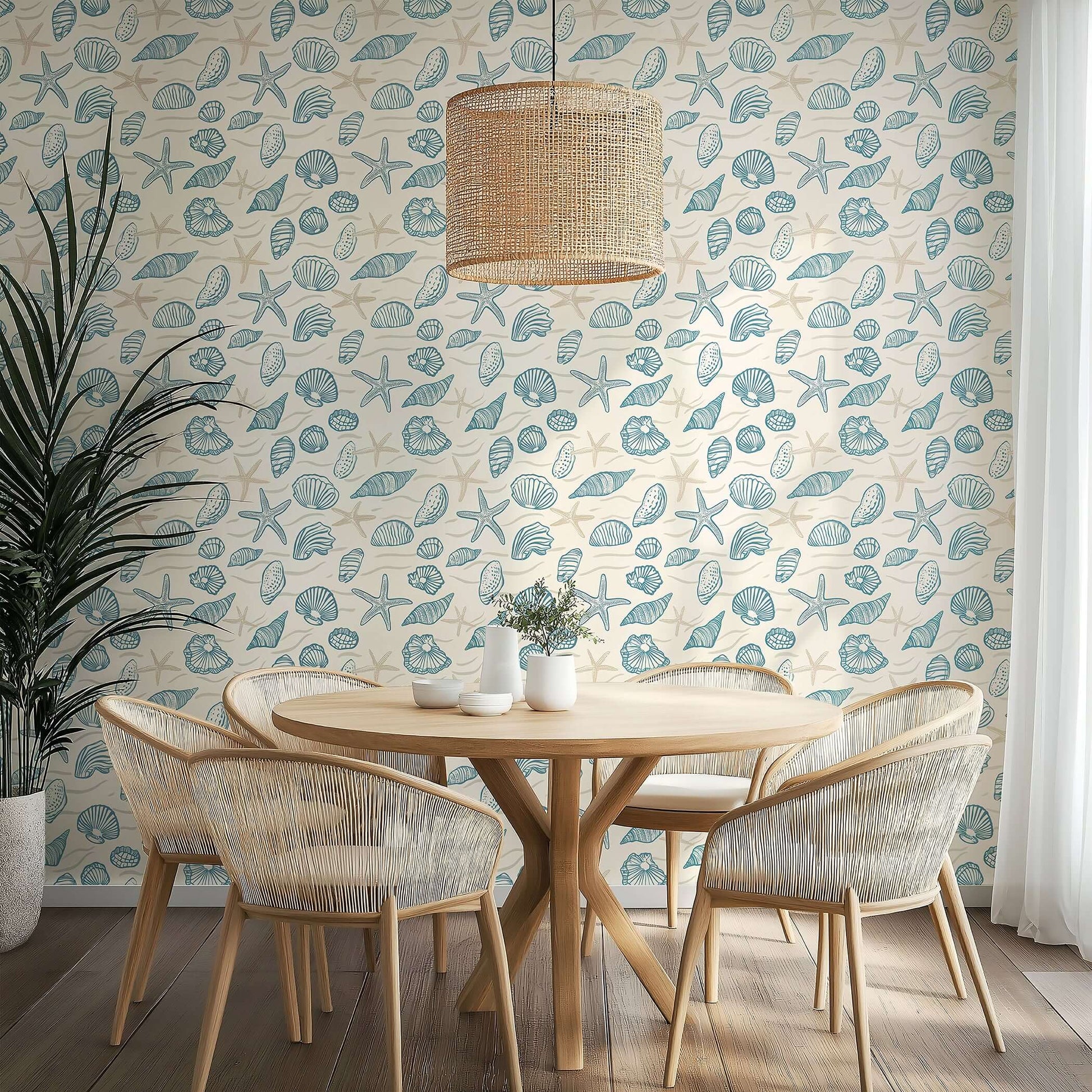 Beachcomber wallpaper featuring hand-drawn seashells and starfish in ocean blues, creating a coastal ambiance in a dining room.