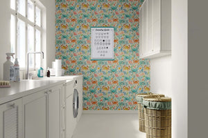 Lively Crab Cove wallpaper with watercolor crabs, coral, and ocean plants in blue, coral, and citrus hues in a coastal-themed room.