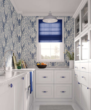Kitchen with Lobster Bay wallpaper showcasing nautical design with navy lobsters and botanical prints on an ivory background.