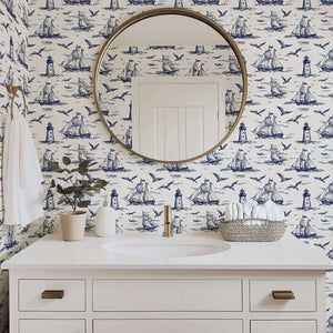 Classic bathroom with "Nautical Odyssey" wallpaper featuring navy ships, seagulls, and lighthouses, enhancing coastal elegance.