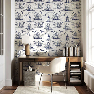 Nautical Odyssey coastal wallpaper featuring navy ships, lighthouses, and seagulls with maritime charm in a home office setting.