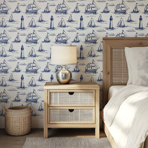 Nautical themed room with Beacon Bay wallpaper featuring vintage sailboats and lighthouses, enhancing coastal maritime decor.