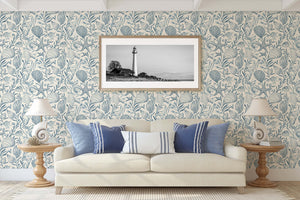 Living room with "Seashell Harmony" wallpaper featuring seashells, starfish, and sea grass in coastal blues, creating a marine theme.