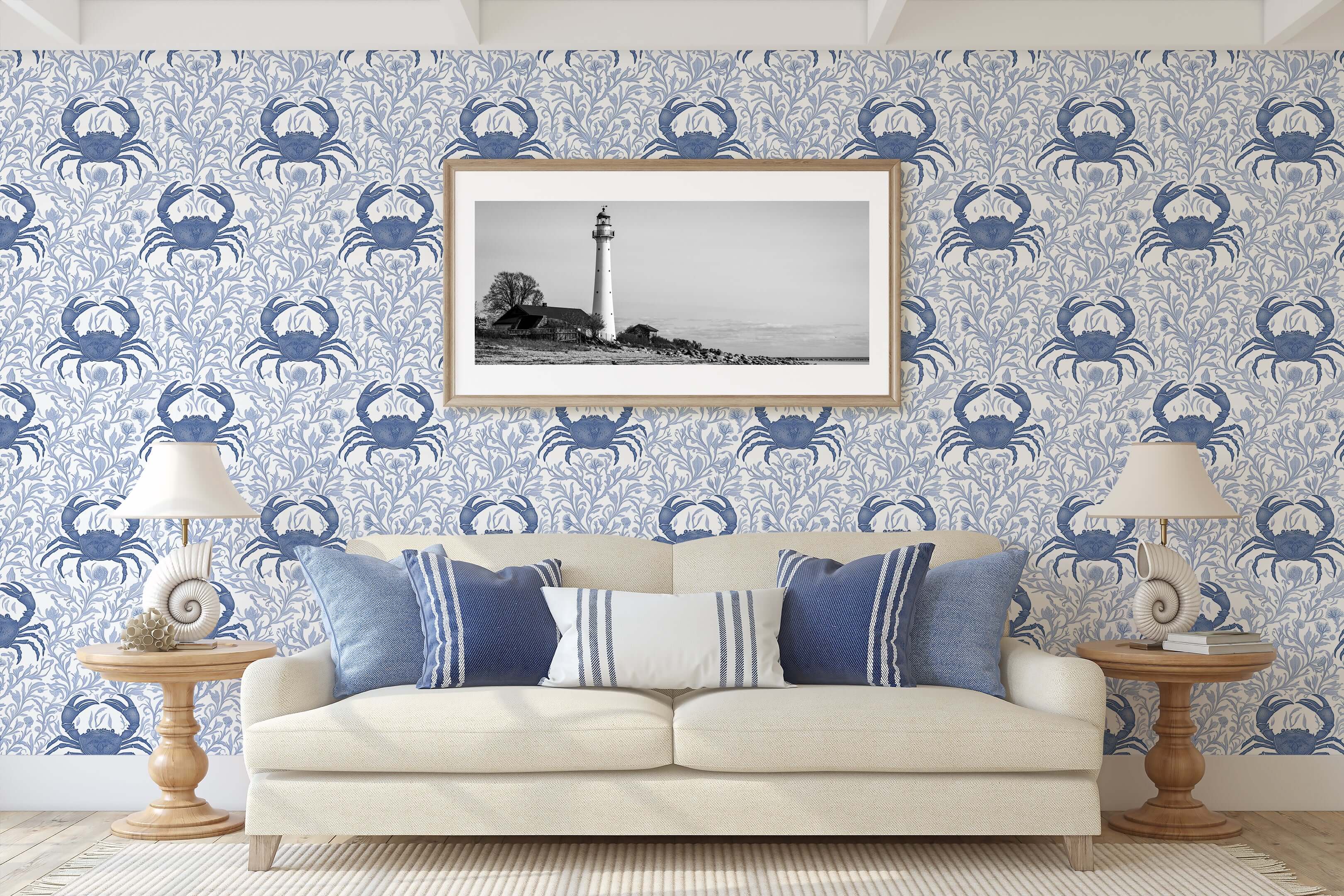 Blue Crab Botanica wallpaper with coastal crabs and ocean flora design in a nautical-themed living room with lighthouse artwork.