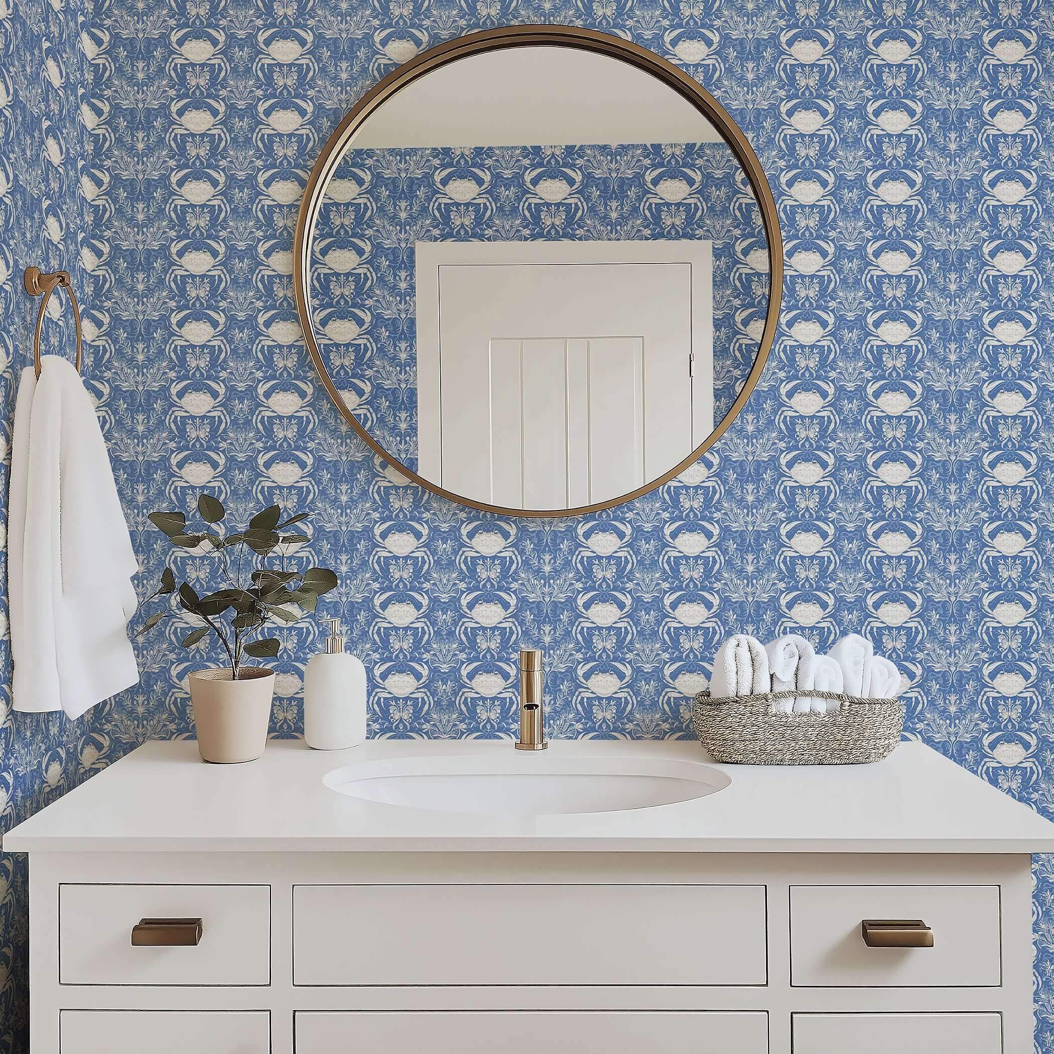 Crab Royale Damask wallpaper in blue with white crabs and seaweed florals, creating a coastal elegance in a bathroom setting.