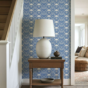 Crab Royale Damask coastal wallpaper with hand-drawn crabs and seaweed on periwinkle blue, enhancing a marine-themed room decor.