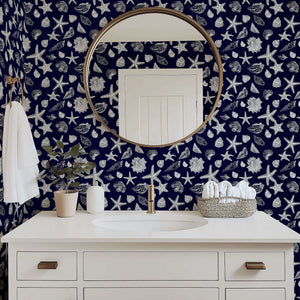 Bathroom with Navy Shore Treasures wallpaper featuring white starfish and seashells on a navy background, enhancing coastal decor.