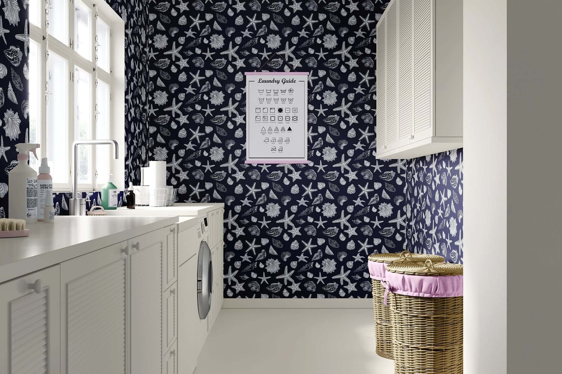 Laundry room with coastal wallpaper featuring white starfish and seashells on a navy background, enhancing beach-themed decor.