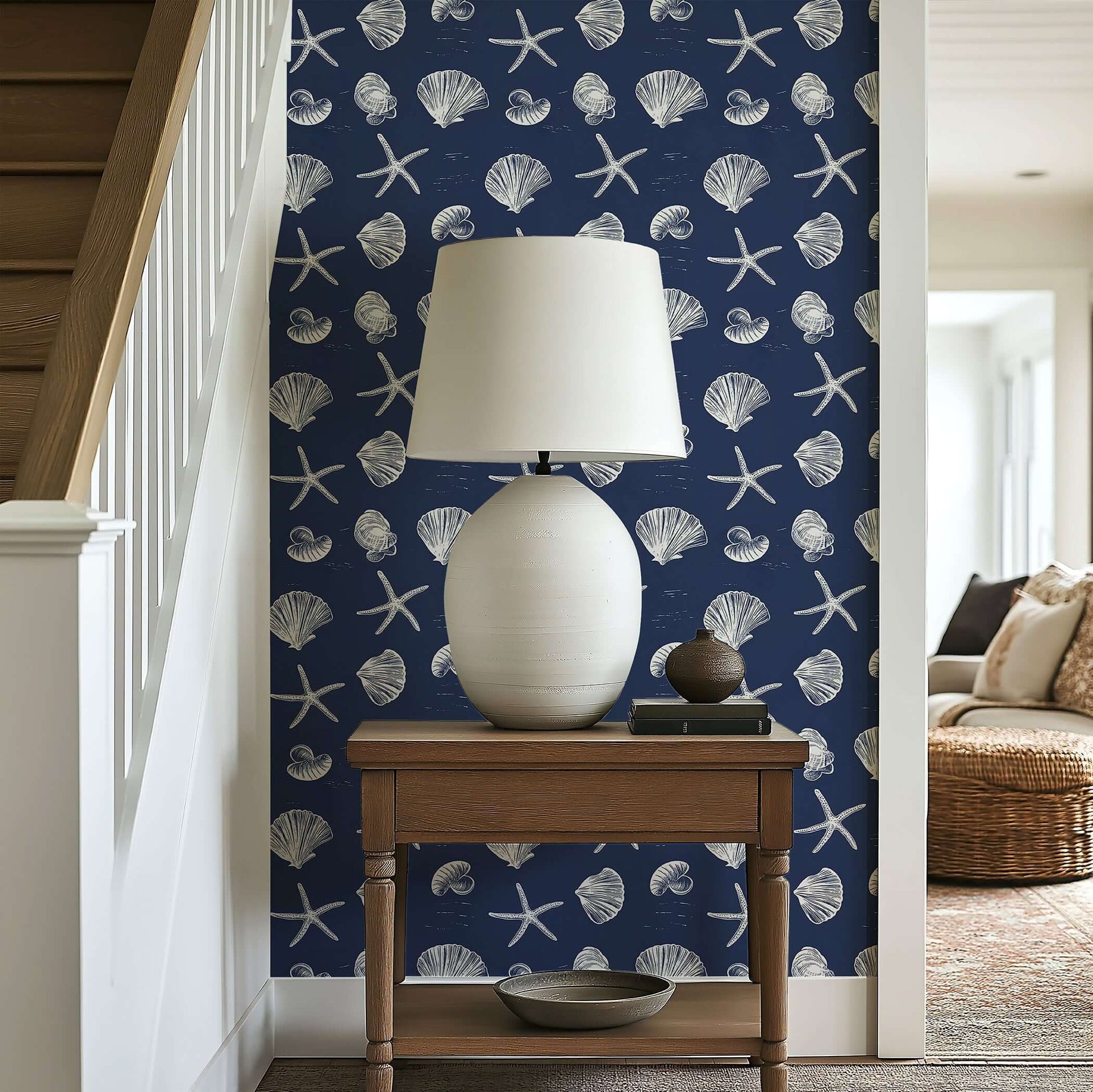 Coastal wallpaper featuring white seashells and starfish on a navy background, perfect for beach and nautical decor.