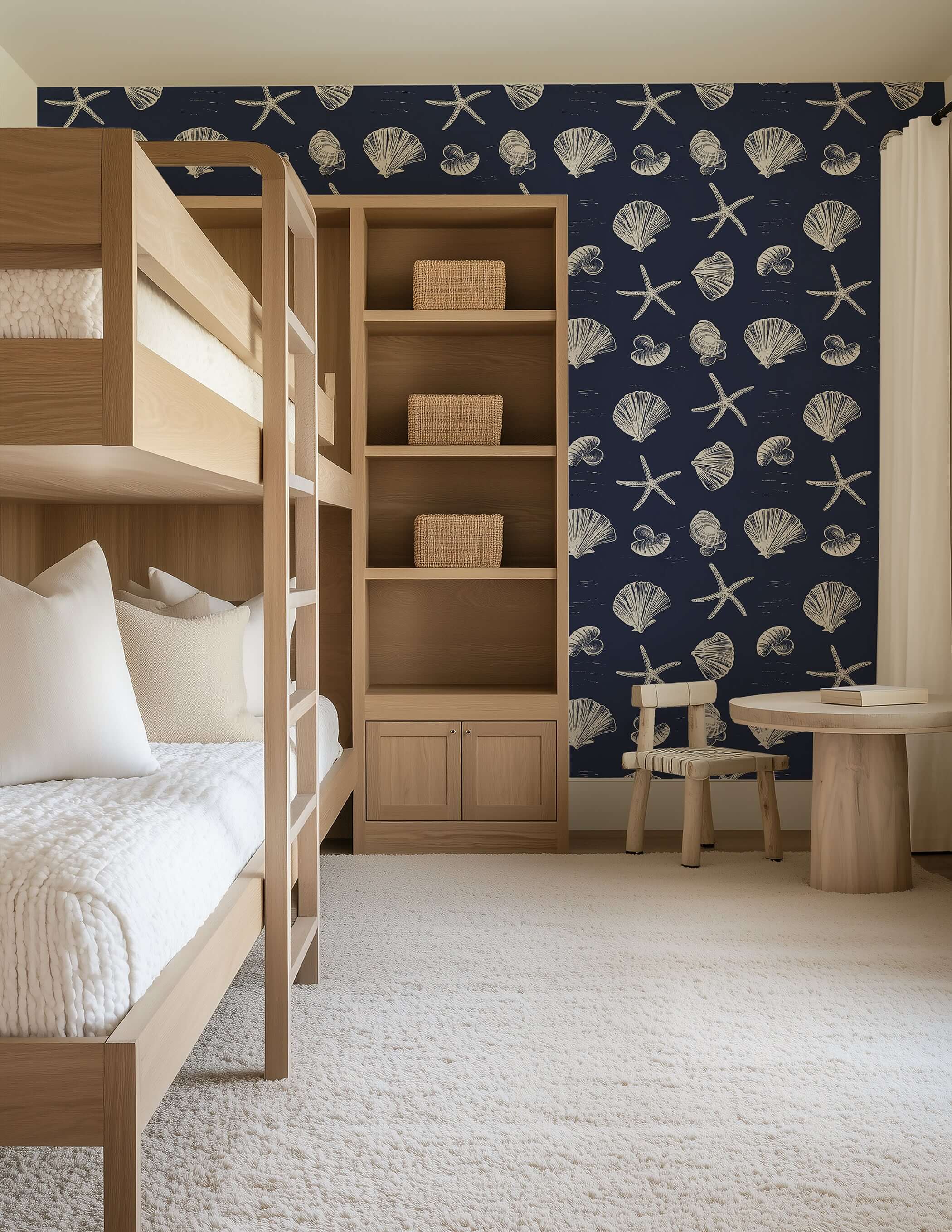Coastal Inked Classics wallpaper featuring starfish and seashells on a navy background in a cozy, beach-inspired bedroom.
