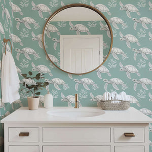 Sage green wallpaper featuring white turtles, coral, and ocean motifs, creating a coastal vibe in a modern bathroom setting.