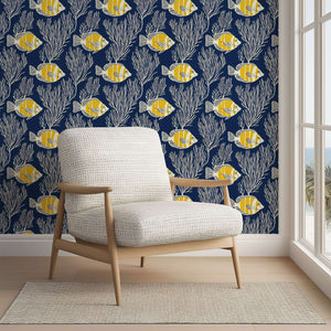 Deep Blue Tropics wallpaper featuring yellow tropical fish and white coral on a navy background, ideal for coastal-themed decor.
