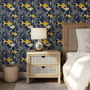 Golden yellow fish and seaweed on navy wallpaper, ideal for coastal themes. Features ocean-inspired design for beach home walls.