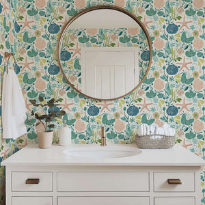 Bathroom with Tidepool Treasures coastal wallpaper featuring ocean motifs like coral, seaweed, and starfish for serene beach vibes.