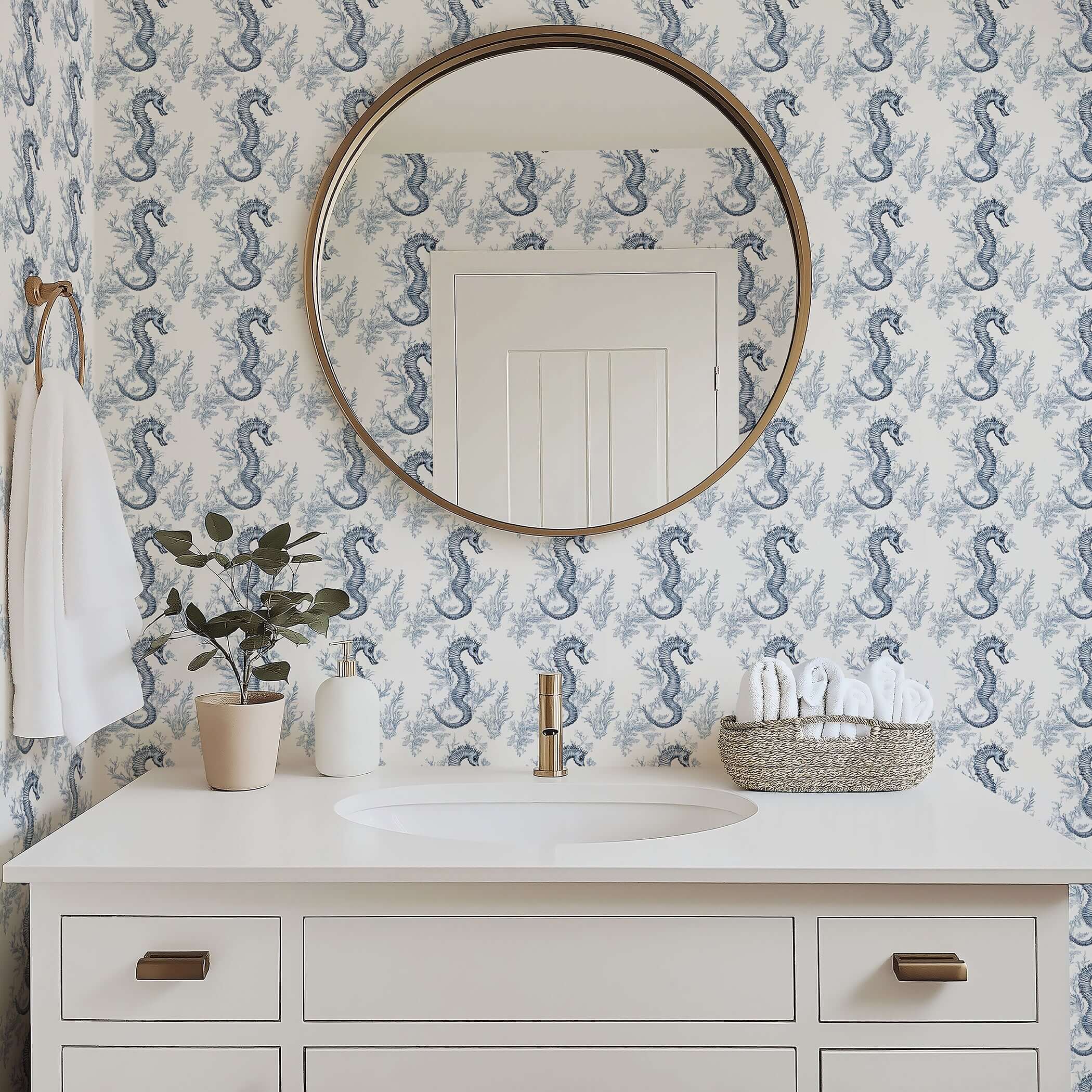 Blue Seahorse Toile Wallpaper in a bathroom, showcasing elegant coastal design with seahorses and ocean plants on white walls.