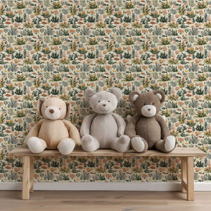 Tropical Tide coastal wallpaper with coral, fish, seaweed design behind three stuffed bears on a wooden bench.