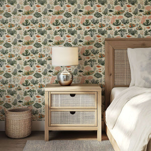Coastal wallpaper with coral, seaweed, and fish pattern in a bedroom setting; modern design by Wall Artifacts.