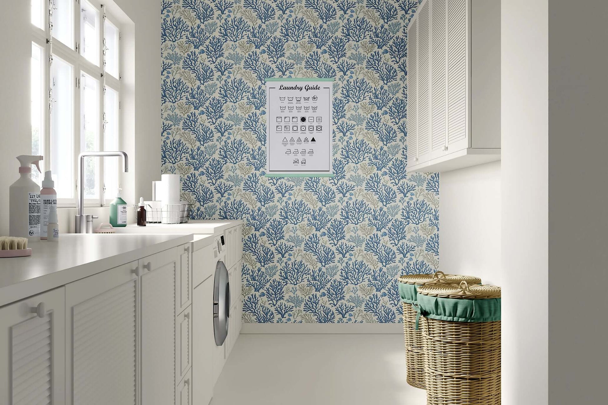 Laundry room with Blue Coral Reef coastal wallpaper, featuring hand-drawn coral branches in ocean blue tones, and wicker baskets.