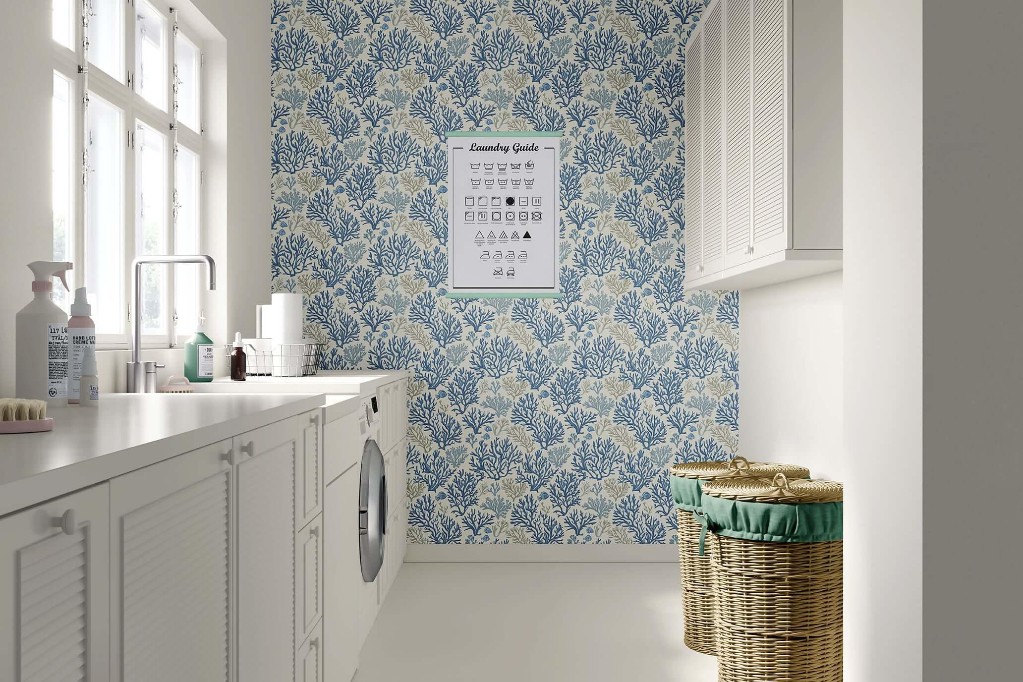 Laundry room with Blue Coral Reef coastal wallpaper, featuring hand-drawn coral branches in ocean blue tones, and wicker baskets.