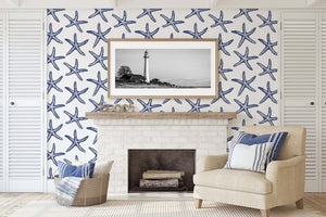 Coastal living room with Seaside Stars wallpaper, featuring blue starfish on white, for a modern beach-inspired design.
