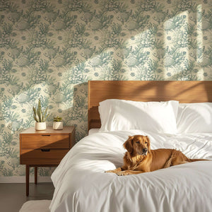 Coastal wallpaper with fish and coral patterns in a bedroom, featuring a dog on a bed, creating a vintage marine theme atmosphere.