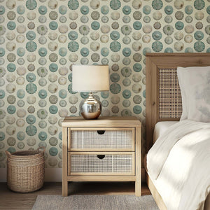 Elegant sea urchin shells wallpaper in ivory, sage, and aqua tones enhances a coastal bedroom with modern beach design.