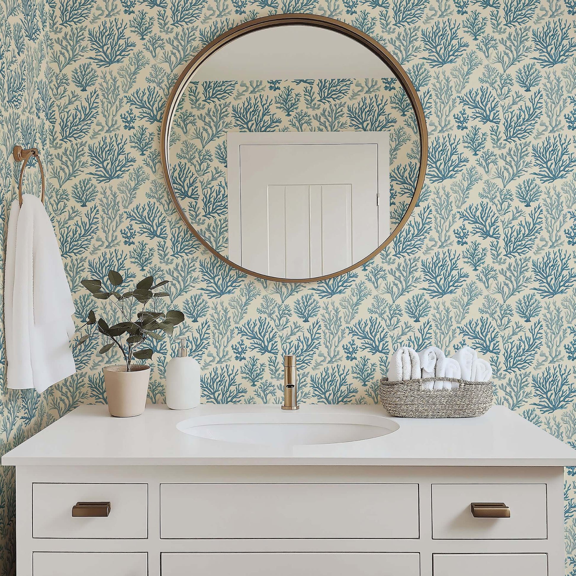 Bathroom featuring Marine Retreat wallpaper with oceanic blue coral design, coastal modern decor, round mirror, and white vanity.