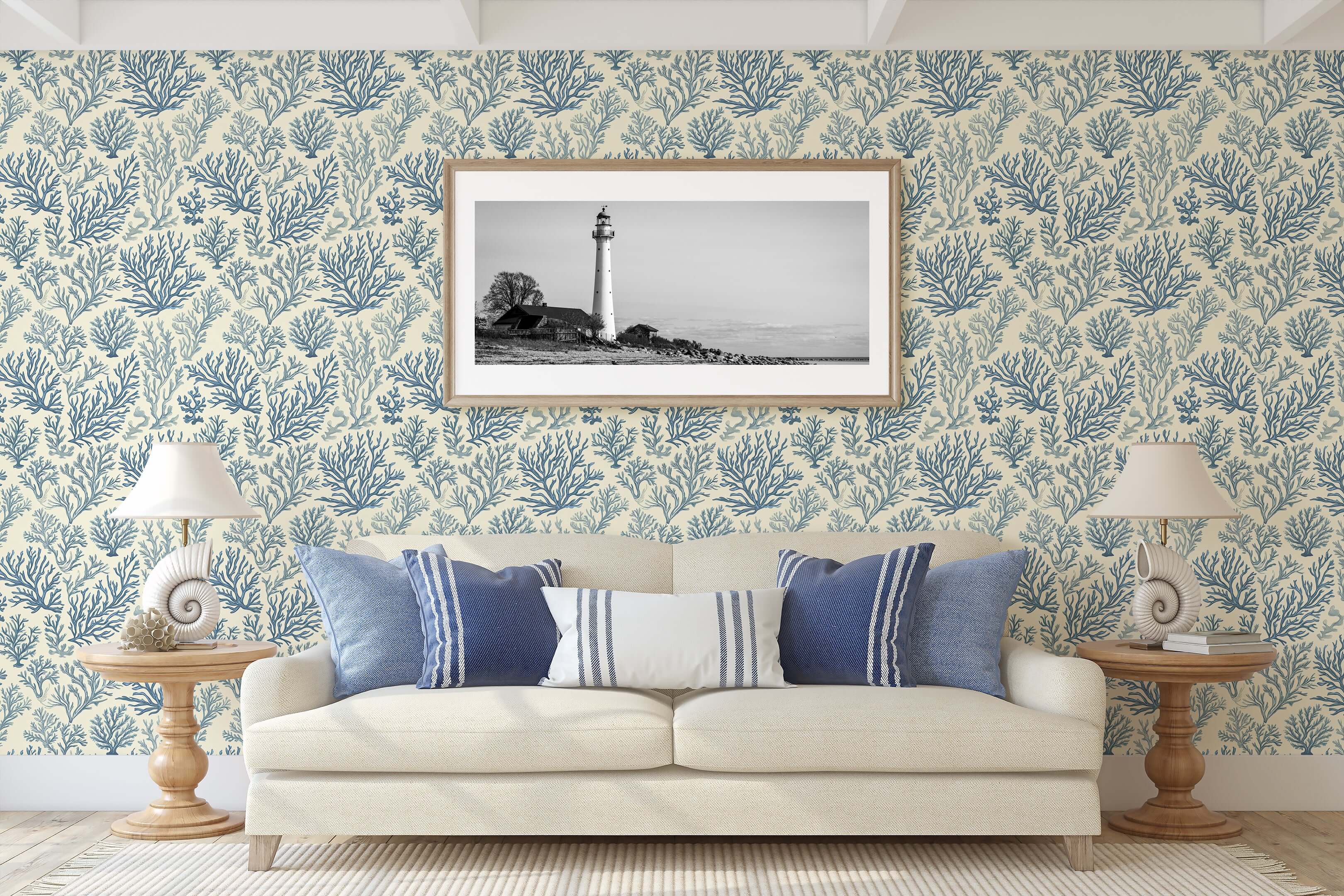 Coastal living room with Marine Retreat wallpaper featuring ocean-inspired coral designs in blue on ivory background, modern coastal decor.