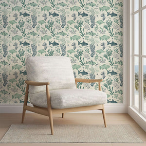 Mid-century modern chair against Aqua Life coastal wallpaper with fish and seaweed design, creating an ocean-inspired atmosphere.