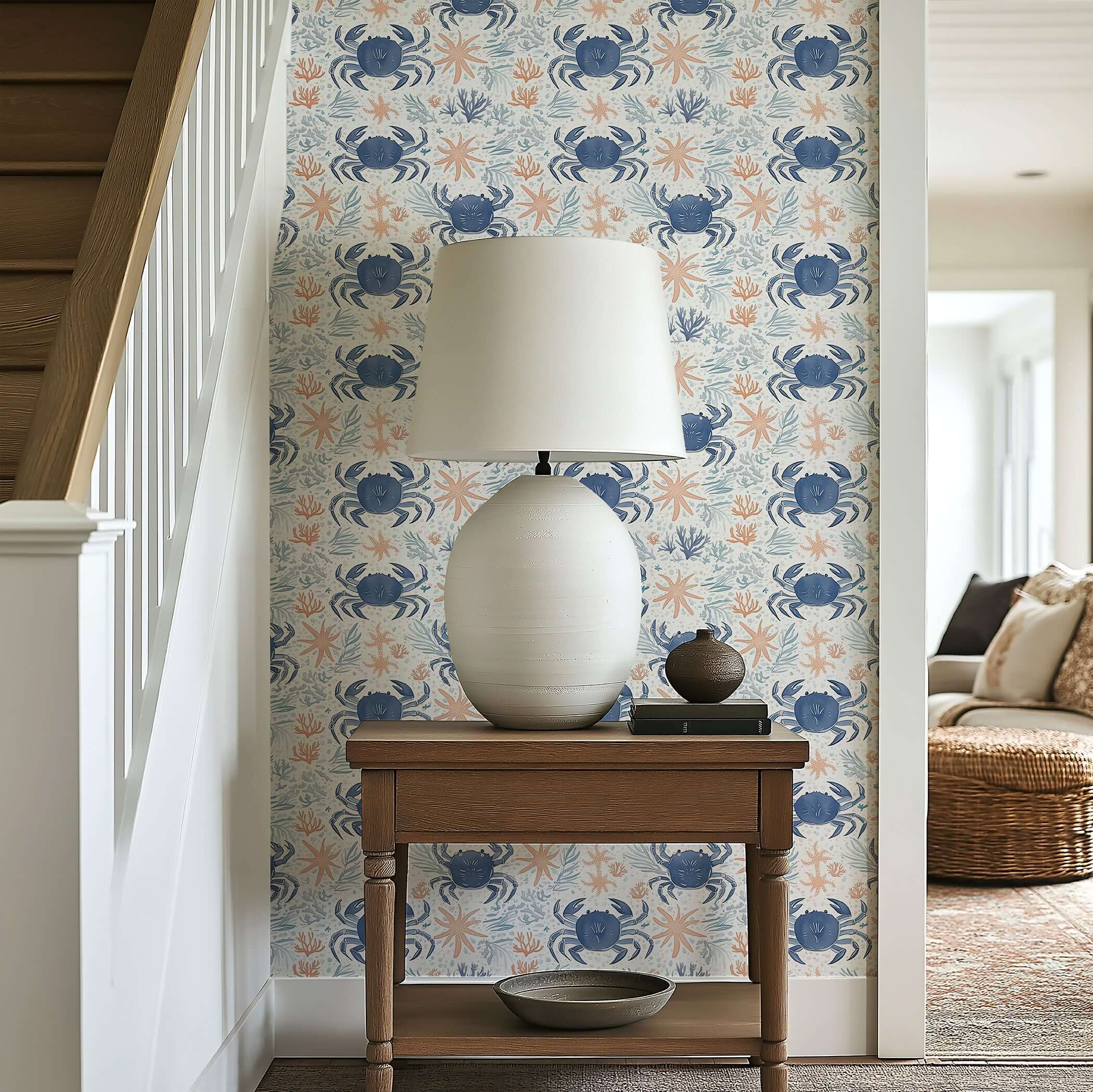 Coastal wallpaper featuring blue crabs, starfish, and coral accents in a modern ocean design, displayed in a stylish interior space.