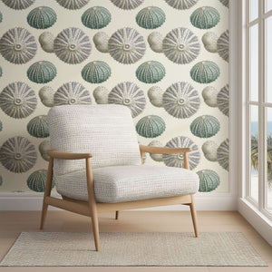 Modern living room with coastal wallpaper featuring elegant sea urchin designs and a stylish armchair, perfect for beach-inspired decor.