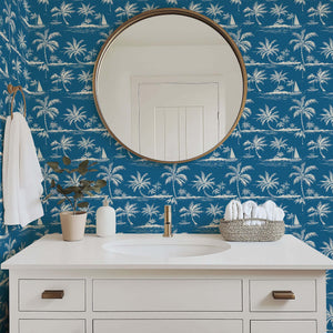 Bathroom featuring 'Blue Hawaii' coastal wallpaper with palm trees and sailboats, creating an elegant beach-inspired toile ambiance.