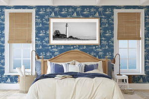 Bedroom with "Palm Paradise" coastal wallpaper featuring palm trees and boats, enhancing a serene beach house decor with French toile style.