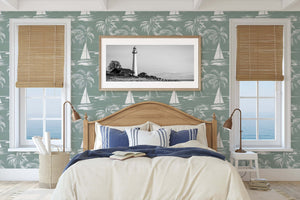 Harbor Escape Wallpaper with boats and palm trees decorates a coastal-themed bedroom, featuring ocean view windows and lighthouse artwork.