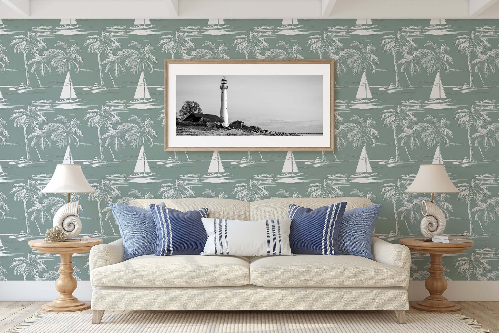 Seafoam green coastal wallpaper with sailboats and palm trees, enhancing a serene nautical-themed living room with a lighthouse artwork.